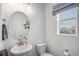 Clean bathroom with pedestal sink, oval mirror, and window at 24257 E 41St Ave, Aurora, CO 80019