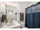 Clean bathroom with a single vanity, shower, and blue shower curtain at 24257 E 41St Ave, Aurora, CO 80019