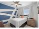 Bright bedroom with a geometric accent wall, neutral carpet, and a comfortable bed at 24257 E 41St Ave, Aurora, CO 80019