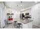 Modern kitchen with stainless steel appliances, a large island with bar stools, and pendant lighting at 24257 E 41St Ave, Aurora, CO 80019