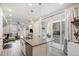 Open concept kitchen with island seating, leading to a living area and outdoor patio at 24257 E 41St Ave, Aurora, CO 80019