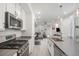 Stylish kitchen featuring stainless steel appliances, a gas range, and an island with a sink at 24257 E 41St Ave, Aurora, CO 80019