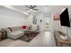 Bright living room with L-shaped sectional sofa and hardwood floors at 24257 E 41St Ave, Aurora, CO 80019