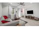 Open living area with gray sectional sofa and hardwood floors at 24257 E 41St Ave, Aurora, CO 80019