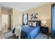 Cozy bedroom with a comfortable queen-sized bed, stylish decor, and a view into the ensuite bathroom at 7459 S Alkire St # 202, Littleton, CO 80127