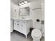 Contemporary bathroom featuring a vanity with marble countertop, a toilet, and black accessories at 2900 N Downing St # 311, Denver, CO 80205