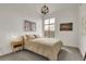 Comfortable bedroom with neutral tones, a modern light fixture, and a large window at 2900 N Downing St # 311, Denver, CO 80205