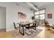 Dining area with modern table, chairs, and decor next to the sliding doors accessing the balcony at 2900 N Downing St # 311, Denver, CO 80205