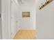 Hallway featuring wood floors, coat rack, and an art piece at 2900 N Downing St # 311, Denver, CO 80205