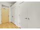 Hallway with neutral walls, wood floors and closet doors at 2900 N Downing St # 311, Denver, CO 80205