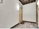 Hallway with wood-look tile flooring, door and 'welcome' mat at 2900 N Downing St # 311, Denver, CO 80205