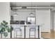 Kitchen featuring a breakfast bar with pendant lights, white cabinets, and stainless steel appliances at 2900 N Downing St # 311, Denver, CO 80205
