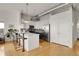 Contemporary kitchen with white upper cabinets, black lower cabinets, stainless appliances, and hardwood floors at 2900 N Downing St # 311, Denver, CO 80205