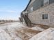 Exterior view of a two-story home with stairs leading to the backyard at 1947 S Coolidge Way, Aurora, CO 80018