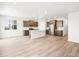 Open-concept living space with hardwood floors and a kitchen island, perfect for modern living at 1947 S Coolidge Way, Aurora, CO 80018