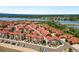 Aerial view showcasing a community with a lake in the background at 2140 Santini Trl # F, Littleton, CO 80129