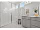 Bright bathroom featuring a glass enclosed shower, modern vanity, and neutral color palette at 2140 Santini Trl # F, Littleton, CO 80129