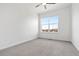 Cozy bedroom with carpet, ceiling fan, and a large window providing natural light at 2140 Santini Trl # F, Littleton, CO 80129