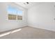 Bright bedroom with a large window providing natural light and carpeted flooring at 2140 Santini Trl # F, Littleton, CO 80129