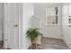 Entryway featuring hardwood flooring, plant in the corner, staircase, and a front door at 2140 Santini Trl # F, Littleton, CO 80129