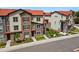 Charming multi-story townhomes featuring a mix of stone and siding exteriors with red roofs at 2140 Santini Trl # F, Littleton, CO 80129