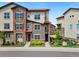 Beautiful townhome featuring a combination of stone and siding, and a well-maintained lawn at 2140 Santini Trl # F, Littleton, CO 80129