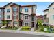 Well-maintained townhomes with a blend of stone and siding accents, complemented by manicured landscaping at 2140 Santini Trl # F, Littleton, CO 80129
