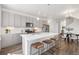 Bright kitchen featuring gray cabinets, quartz countertops, pendant lighting, and stainless steel appliances at 2140 Santini Trl # F, Littleton, CO 80129