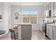 Modern kitchen area featuring a large window, stainless steel appliances and quartz countertops at 2140 Santini Trl # F, Littleton, CO 80129