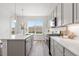 Spacious kitchen featuring stainless steel appliances, gray cabinetry, and pendant lights at 2140 Santini Trl # F, Littleton, CO 80129