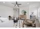 Well-lit living room featuring neutral furniture, a dark rug, and an adjacent office area at 2140 Santini Trl # F, Littleton, CO 80129