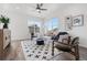 Bright living room with a ceiling fan, lots of natural light, and neutral furniture at 2140 Santini Trl # F, Littleton, CO 80129