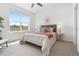 Bright main bedroom featuring a decorative ceiling fan, large window, and stylish lamps at 2140 Santini Trl # F, Littleton, CO 80129