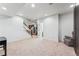 Large basement space with a staircase, neutral carpet, and access to other rooms at 1082 Roslyn St, Denver, CO 80230