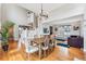 Elegant dining room with wood table, hardwood floors, and an open layout connected to the living room at 1082 Roslyn St, Denver, CO 80230