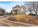 Attractive two-story home with brick accents, a well-manicured lawn, and a welcoming entrance at 1082 Roslyn St, Denver, CO 80230