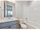 Modern bathroom featuring a tub-shower combination, toilet, and vanity with ample lighting at 1783 Morgan Dr, Erie, CO 80516