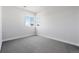 A bright bedroom with plush carpeting and a window with a view at 1783 Morgan Dr, Erie, CO 80516