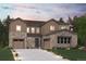 Beautiful two-story home boasts stone accents, a welcoming driveway and professional landscaping at 1783 Morgan Dr, Erie, CO 80516