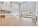 Open-concept great room features high ceilings, light hardwood floors, and a seamless connection to the kitchen at 1783 Morgan Dr, Erie, CO 80516
