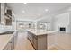 Modern kitchen boasts stainless steel appliances, quartz countertops, and hardwood floors, perfect for culinary enthusiasts at 1783 Morgan Dr, Erie, CO 80516