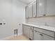 Laundry room with gray cabinets, a sink, and connections for a washer and dryer at 1783 Morgan Dr, Erie, CO 80516