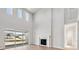Bright living room boasts soaring ceilings, expansive windows, and a modern fireplace at 1783 Morgan Dr, Erie, CO 80516