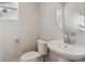 Cozy powder room with modern fixtures, pedestal sink, and convenient layout at 1783 Morgan Dr, Erie, CO 80516
