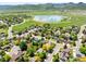 Aerial view showcasing a suburban community near a lake and mountains at 6008 S Van Gordon St, Littleton, CO 80127