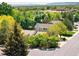 Residential neighborhood aerial view with lush green trees and mountain views at 6008 S Van Gordon St, Littleton, CO 80127