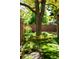 Beautifully landscaped backyard featuring lush green grass, mature trees, and stone border at 6008 S Van Gordon St, Littleton, CO 80127