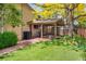 Backyard featuring a covered patio, green grass, and landscaping at 6008 S Van Gordon St, Littleton, CO 80127