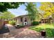 Charming backyard with brick pathway, lush lawn, and mature landscaping at 6008 S Van Gordon St, Littleton, CO 80127