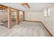 Unfinished basement area is shown with shelving and neutral colored carpet at 6008 S Van Gordon St, Littleton, CO 80127